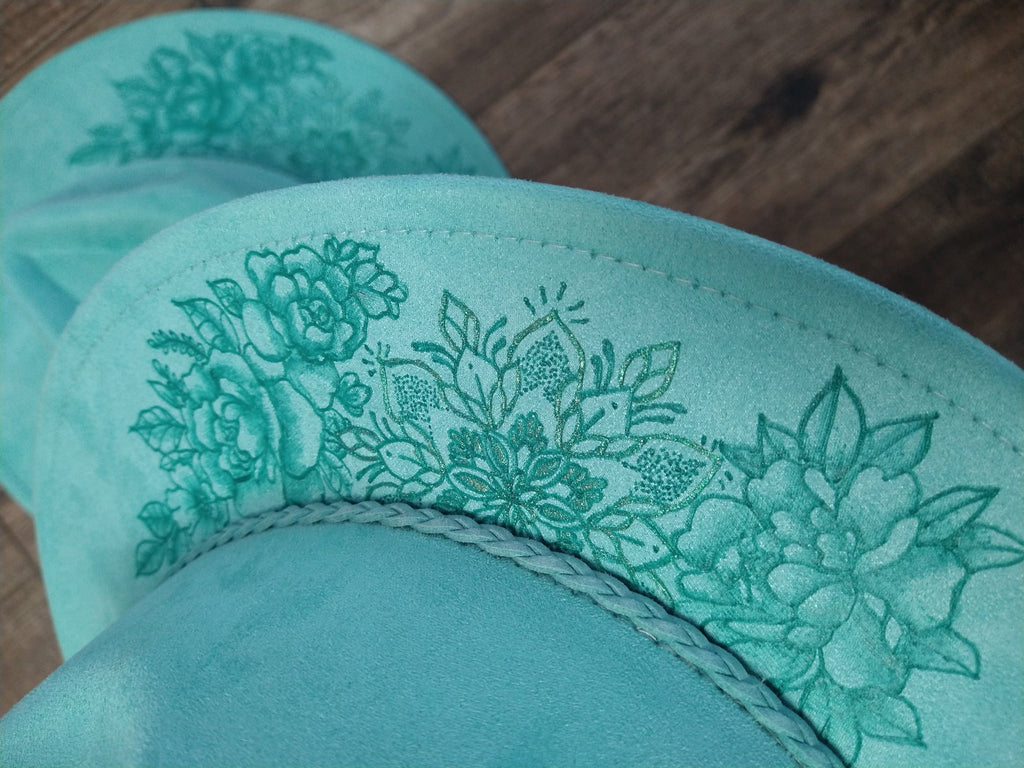 Teal fabric with floral on a wooden surface