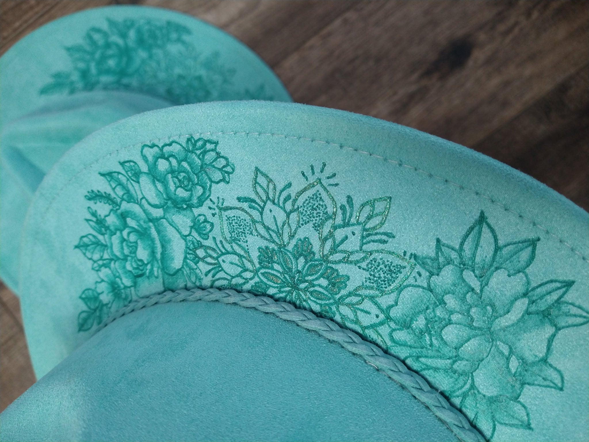 Teal fabric with floral on a wooden surface