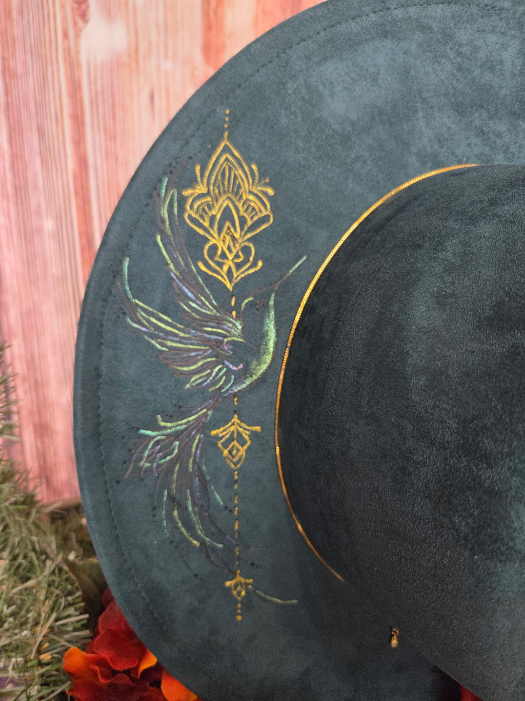 Decorative hat with intricate gold and multicolored design on a dark background