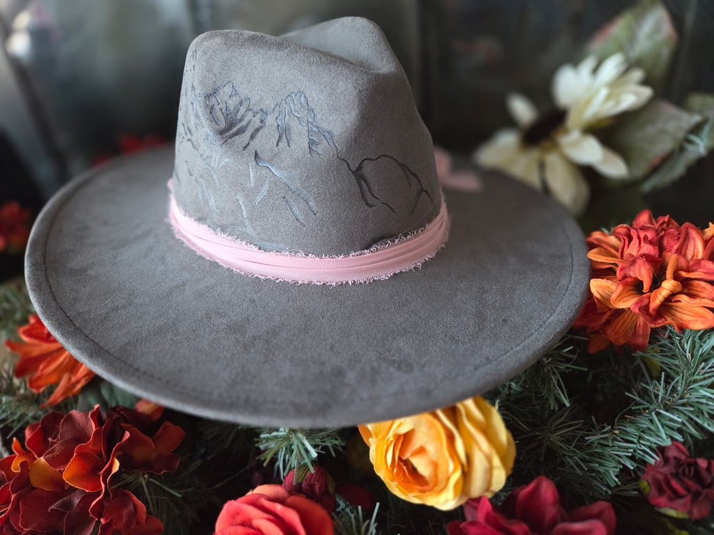 Gray hat with pink band on a floral background