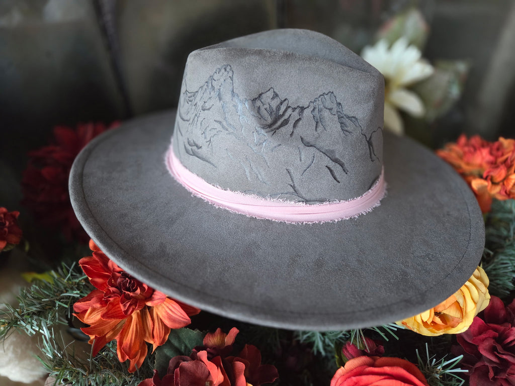 Gray hat with pink band on a floral background