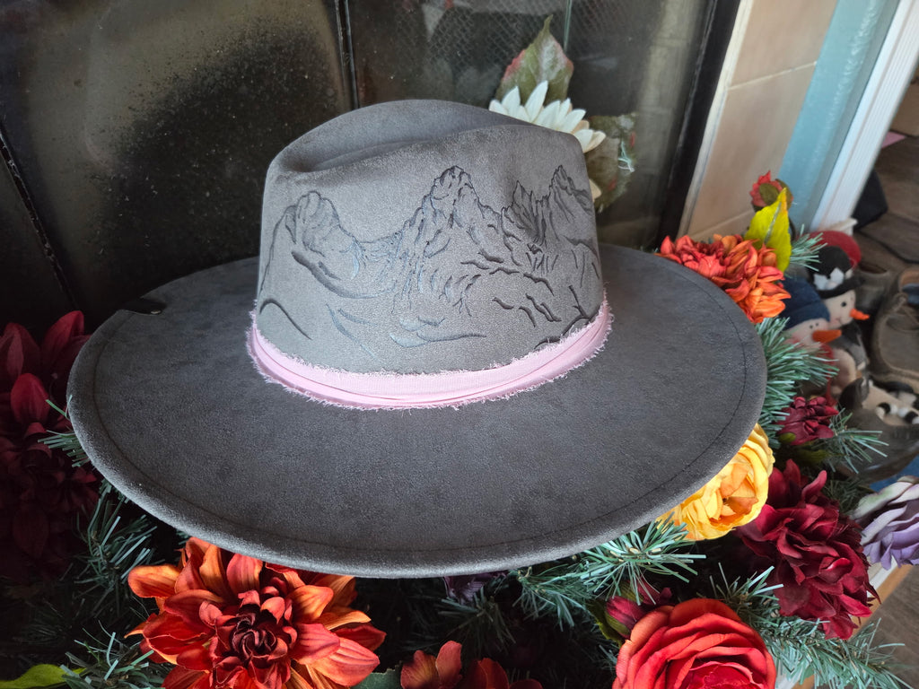 Gray hat with floral and decorative elements in the background